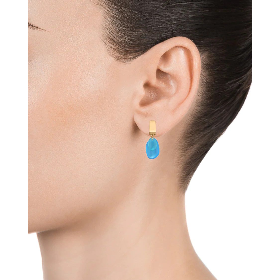 Blue teardrop earring worn by a person with dark hair and light skin.