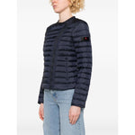 Person wearing a dark blue puffer jacket on a white background