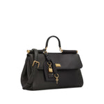 Black handbag with gold accents on a white background