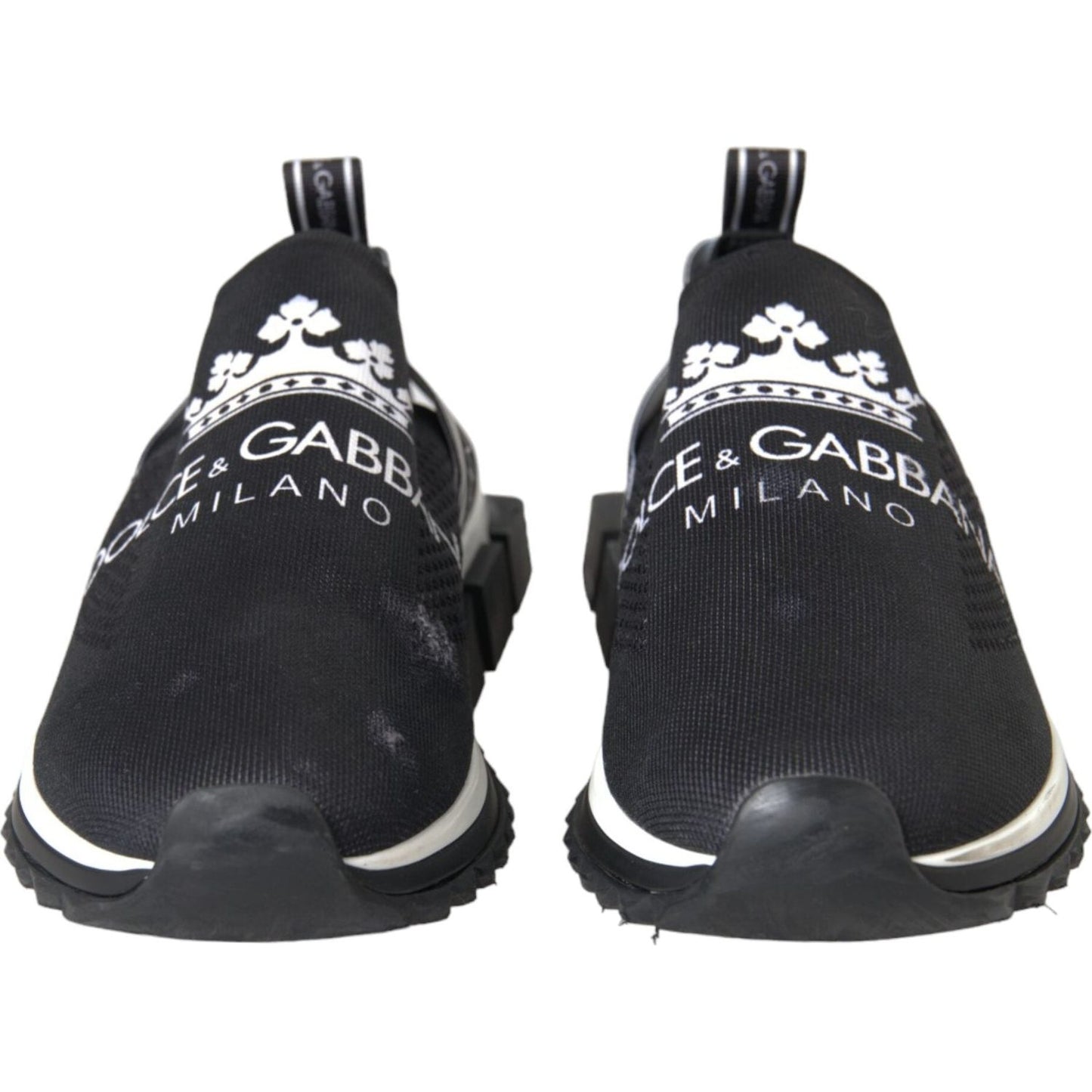 Dolce & Gabbana black and white 'Sorrento' slip-on sneakers with logo print and rubber sole from front view.