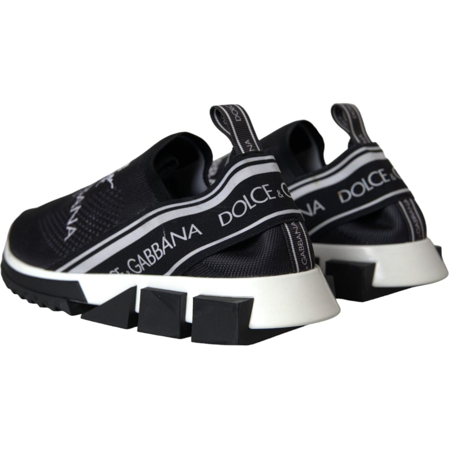Dolce & Gabbana Sorrento slip-on sneakers in black and white with logo print, fabric pull strap, and rubber sole.