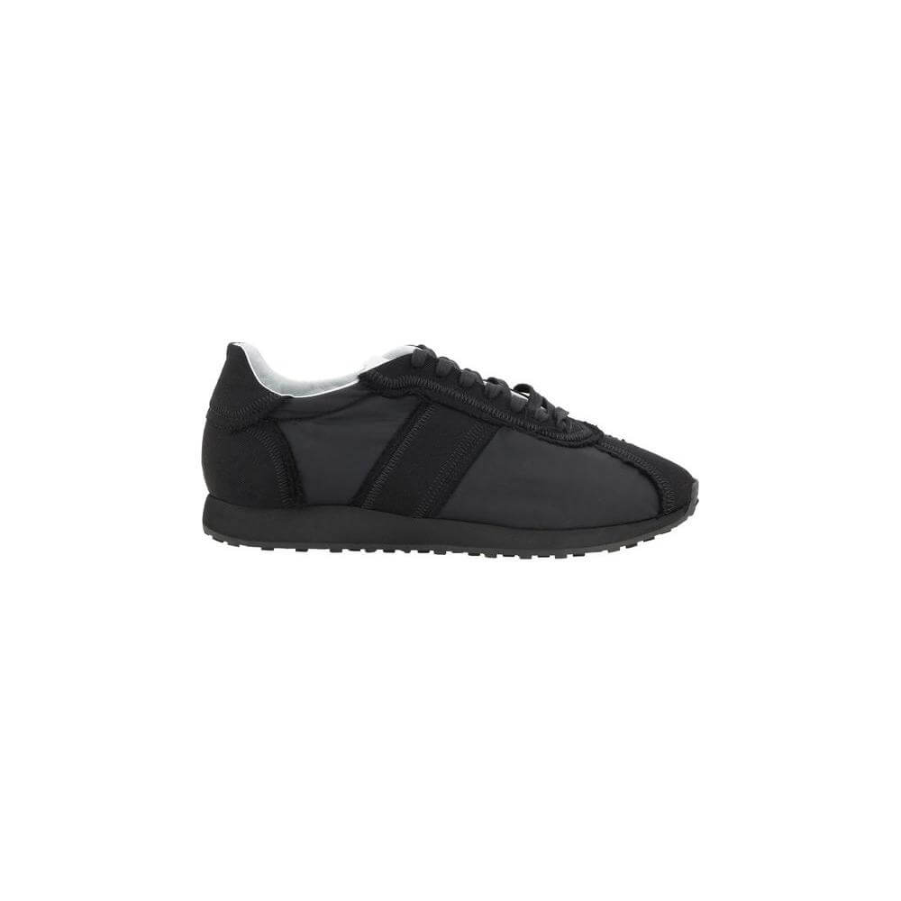 The Row Moveo Sneakers in black with lace-up front, round toe, and tone-on-tone slanted bands, featuring modern strappy details.