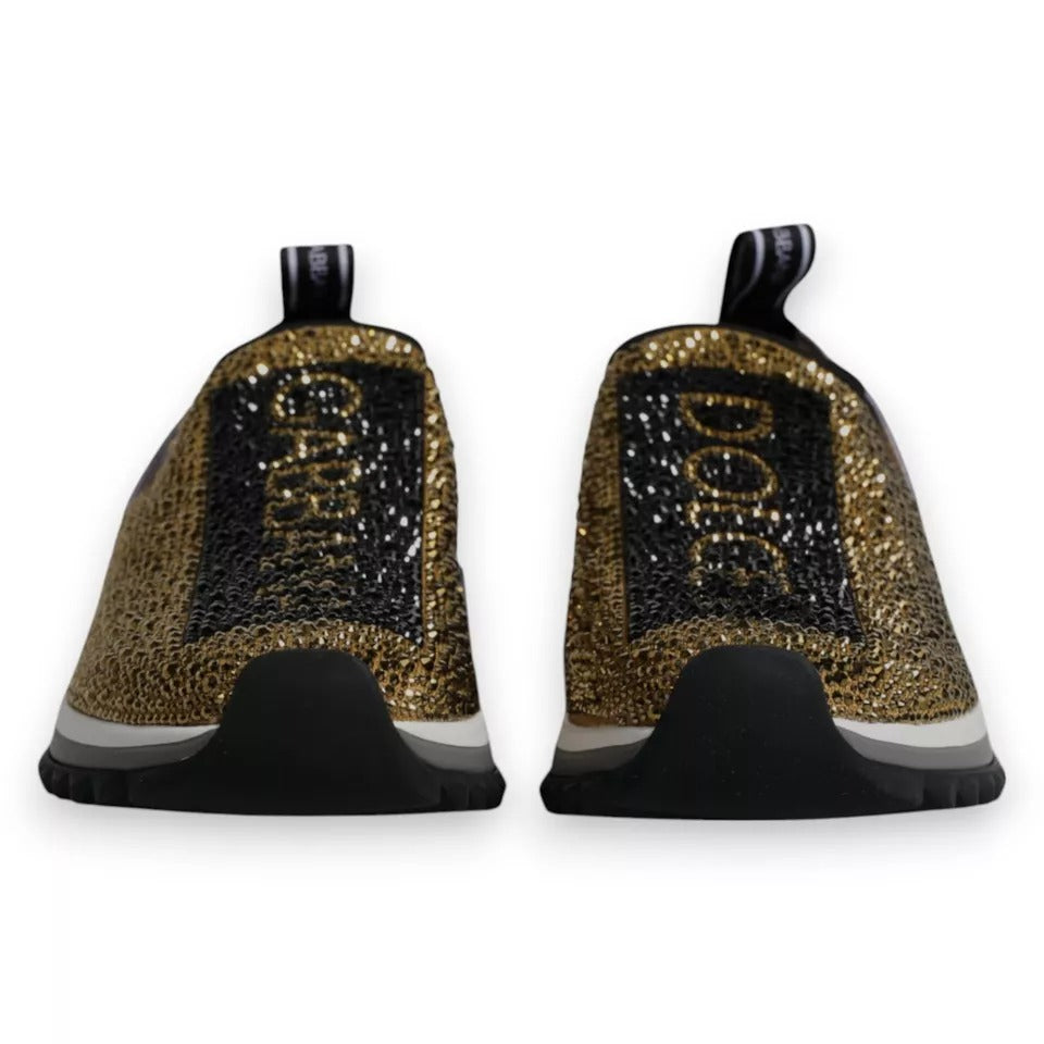 Back view of Dolce & Gabbana gold rhinestone Sorrento sneakers with black logo detail and ridged rubber sole.