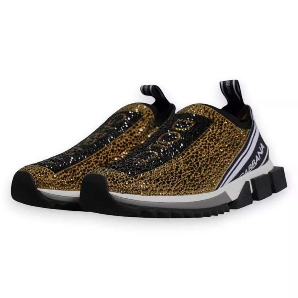 Dolce & Gabbana Sorrento sneakers in gold with rhinestones, featuring a round toe, slip-on style, pull tab, and ridged rubber sole.