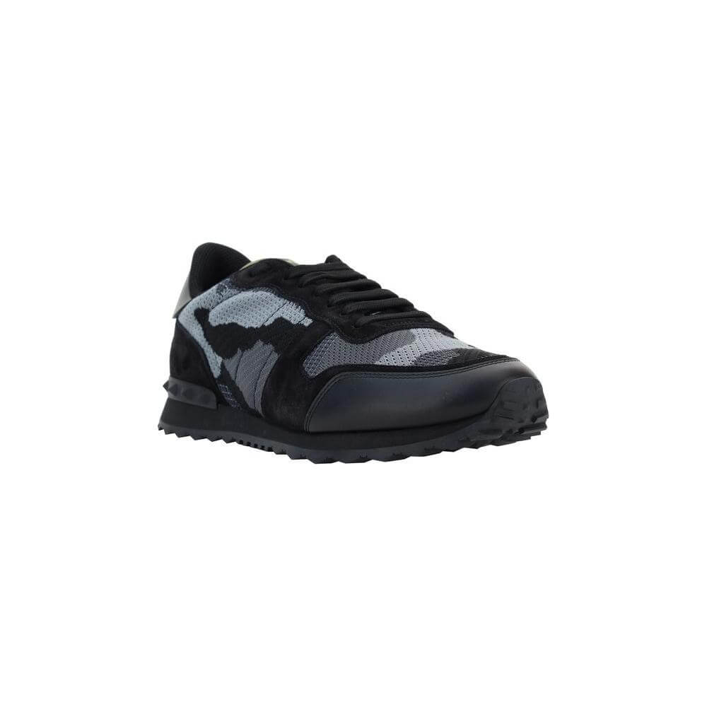 Valentino Garavani sneakers featuring a lace-up front, camouflage design, leather details, and iconic brand studs at the heel.