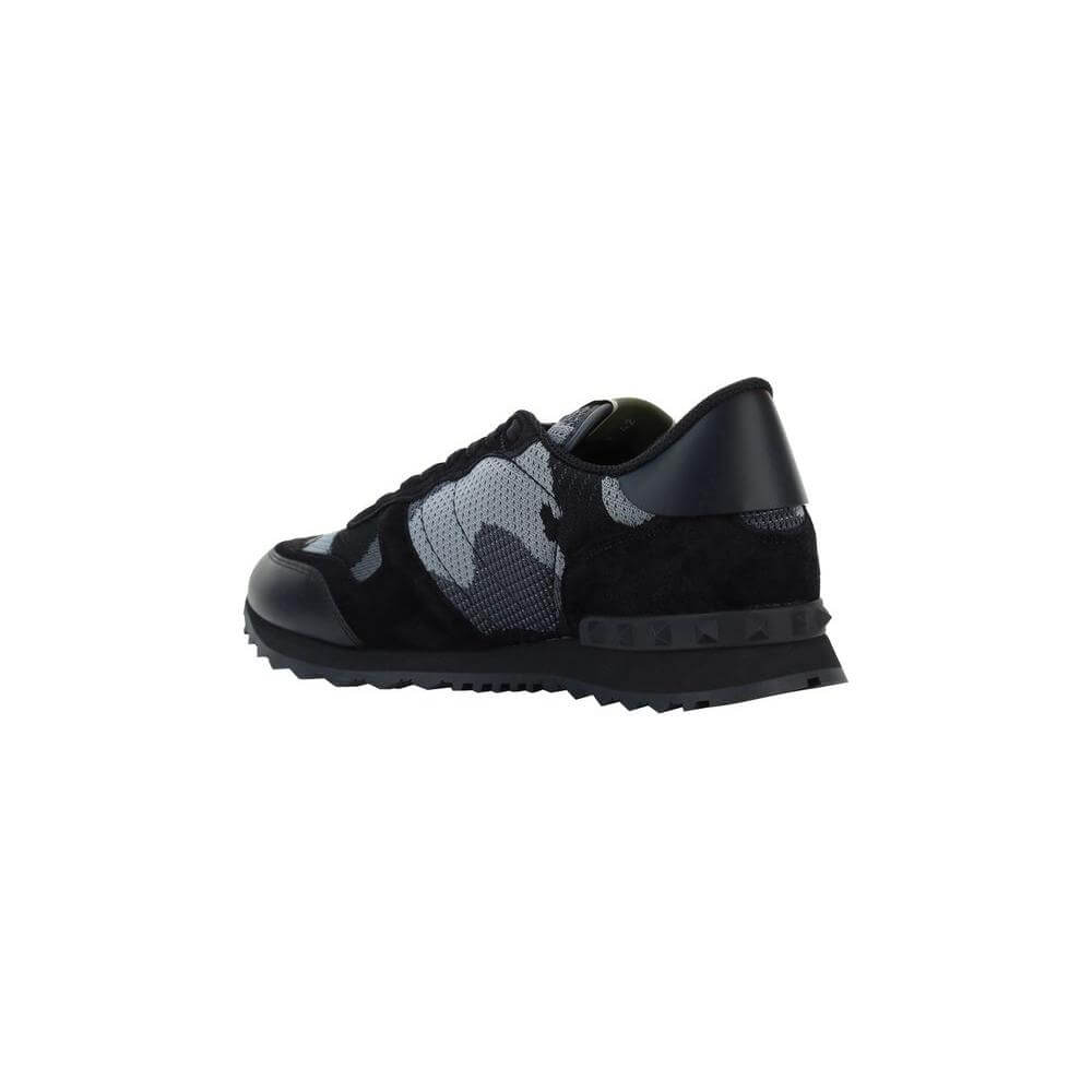 Valentino Garavani sneakers with lace-up front, round toe, leather detail, textured sole, brand studs, camouflage design.