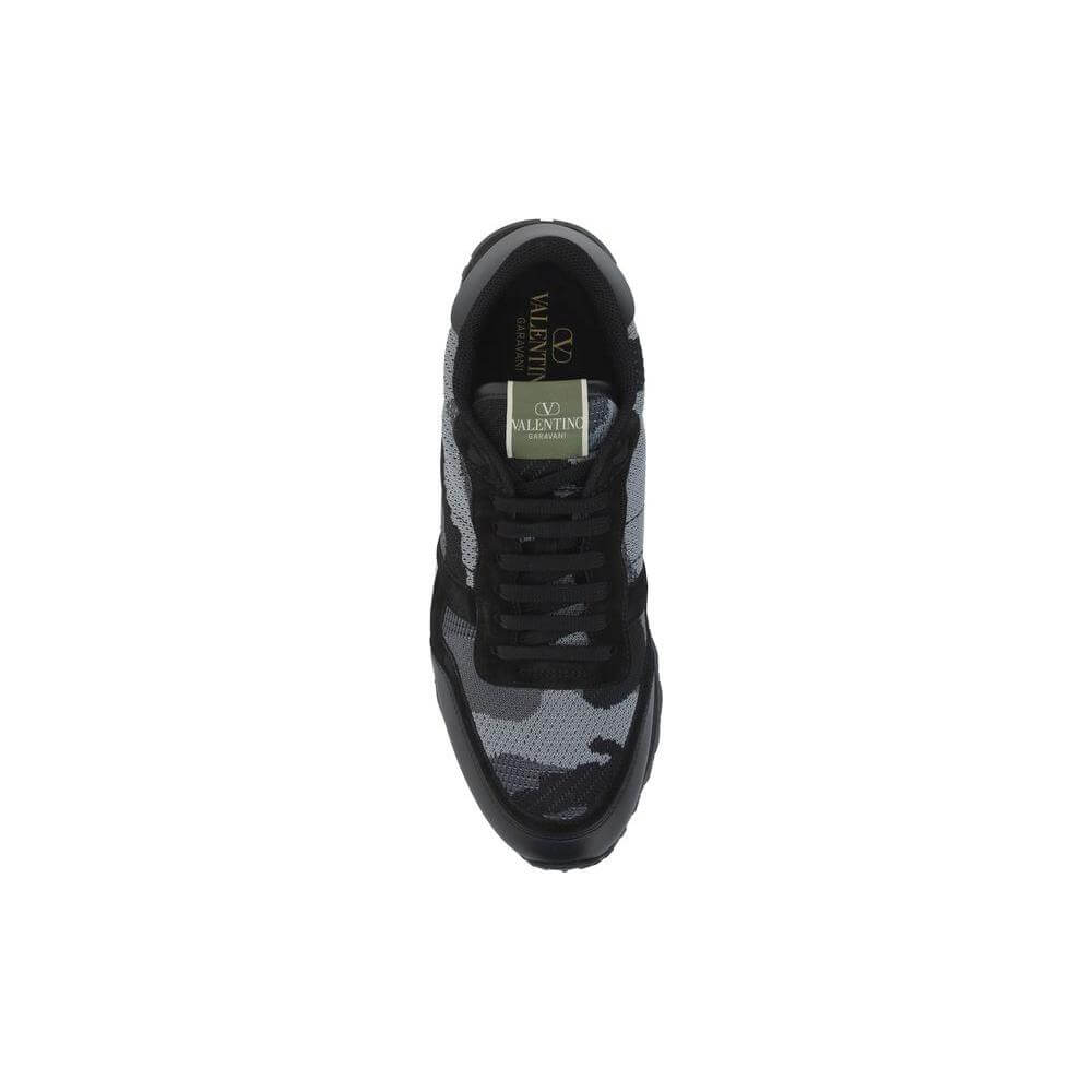 Top view of Valentino Garavani sneakers with lace-up closure, camouflage design, and iconic studs on heel.