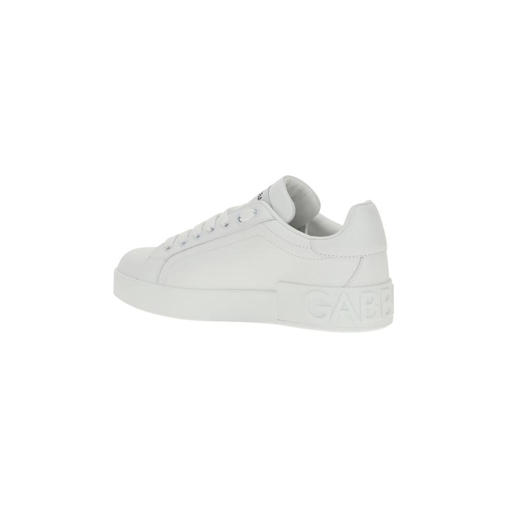 Dolce & Gabbana white leather sneakers with logoed flat sole and lace-up closure, showcasing elegance and comfort in side profile view.