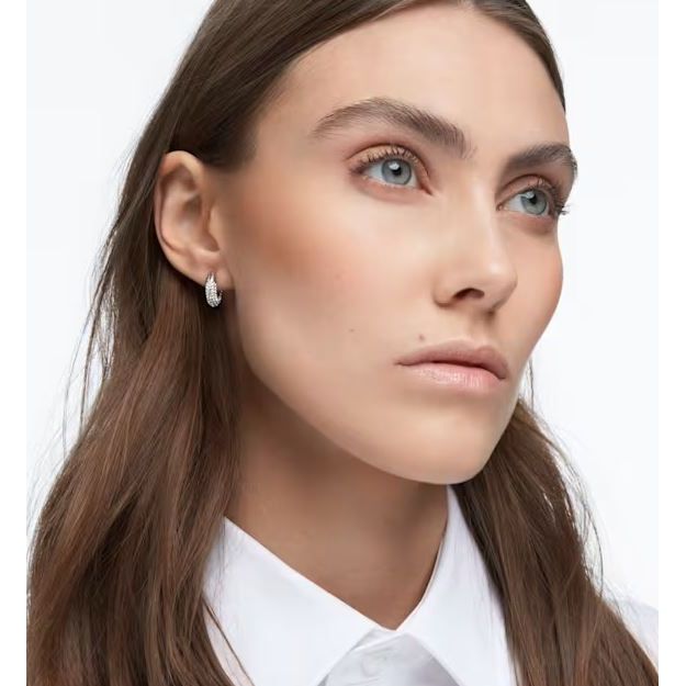 Woman wearing SWAROVSKI Mod. 5618306 earrings made of Silver 925°, featuring a quartz analog movement, in official packaging.