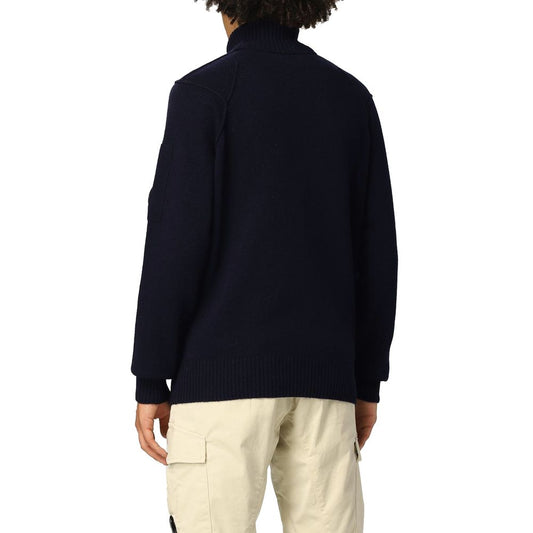 C.P. Company Blue Wool Sweater with ribbed turtleneck and plastic logo plaque on shoulder, shown from the back.