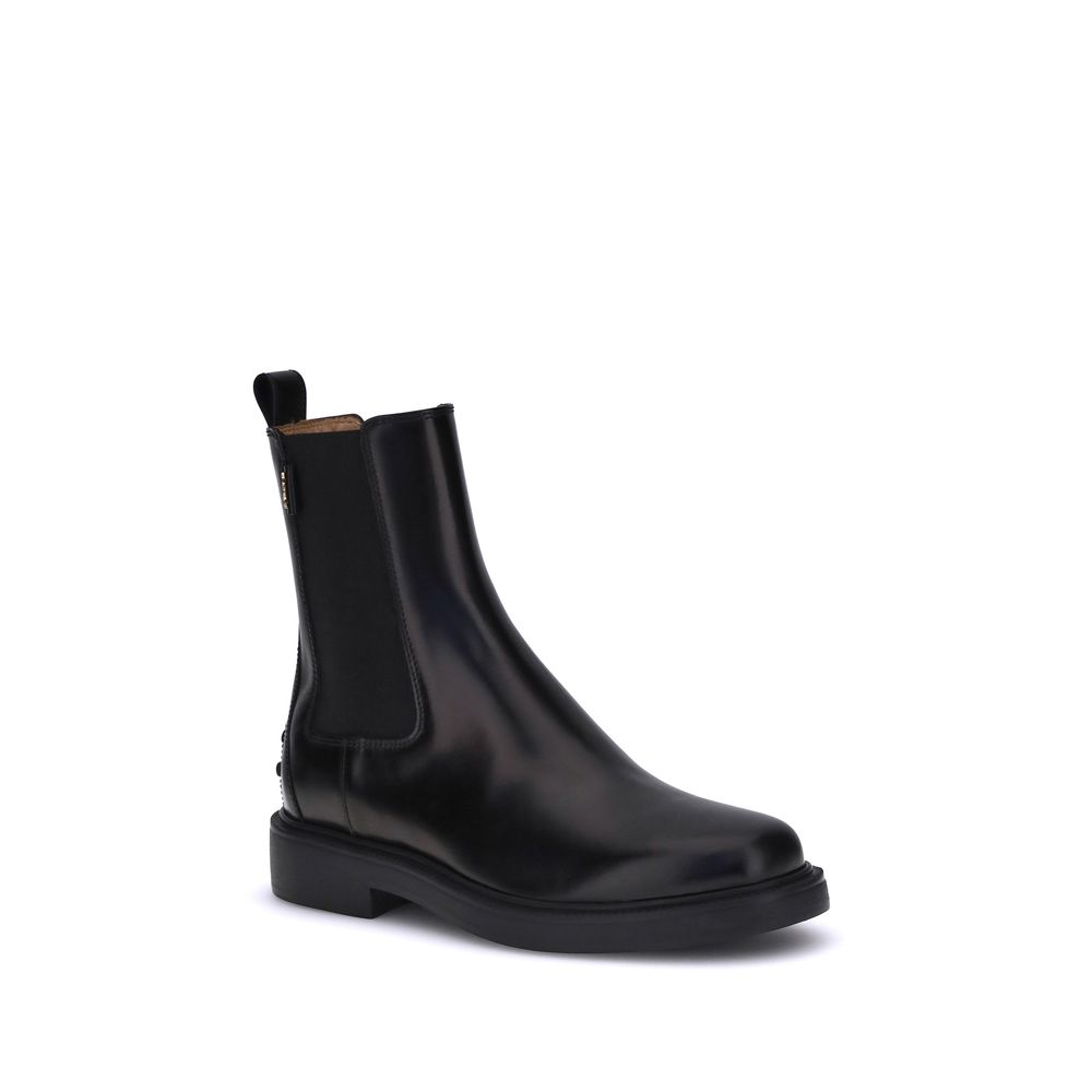Tod's Black Calf Leather Bos Taurus Chelsea Boots with elastic side inserts and rubber sole, featuring a clean, timeless design.