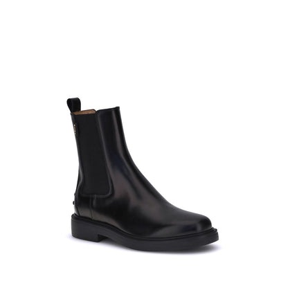 Tod's Black Calf Leather Bos Taurus Chelsea Boots with elastic side inserts and rubber sole, featuring a clean, timeless design.