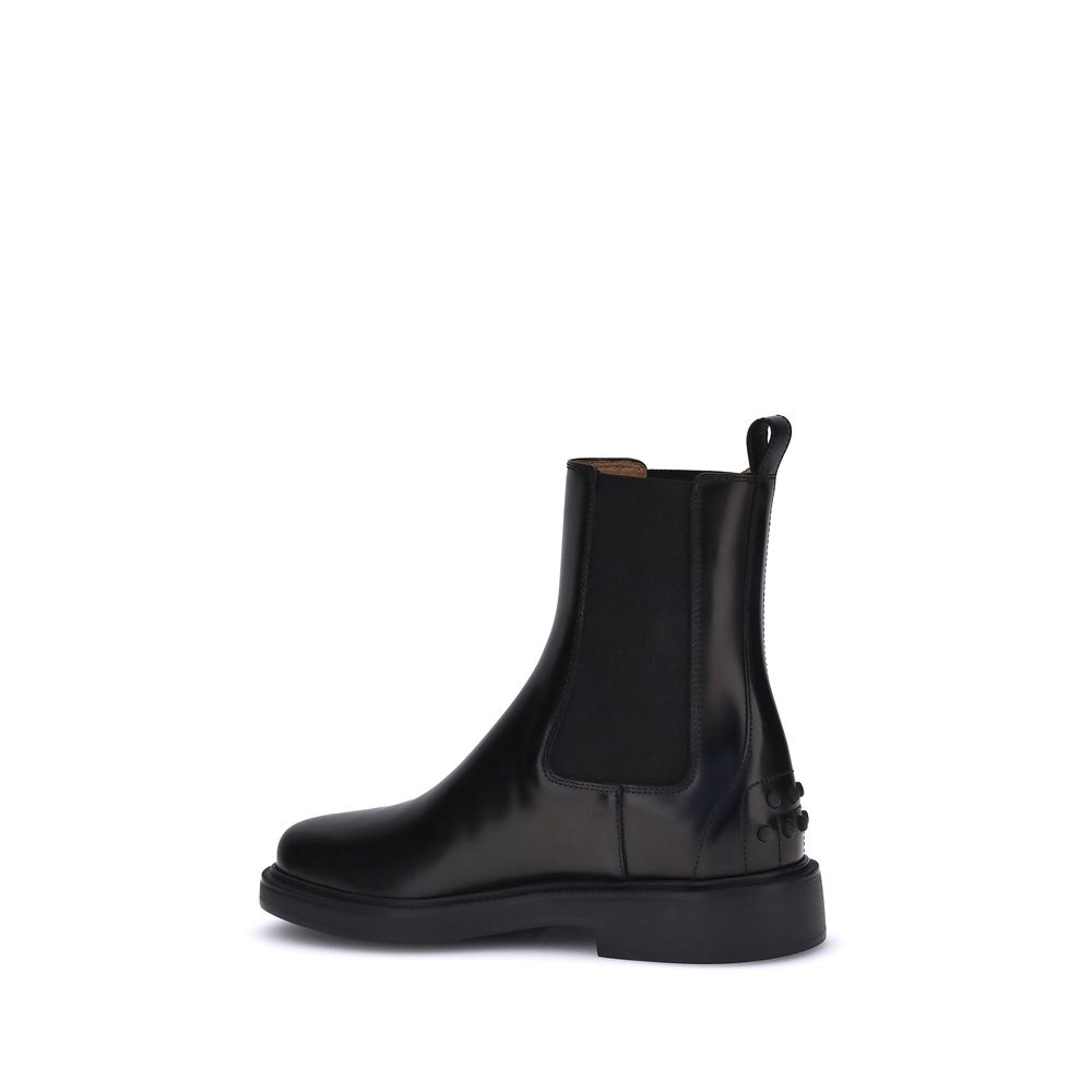 Side view of Tod's Black Calf Leather Bos Taurus Chelsea Boots with elastic inserts and embossed pebble rubber sole.