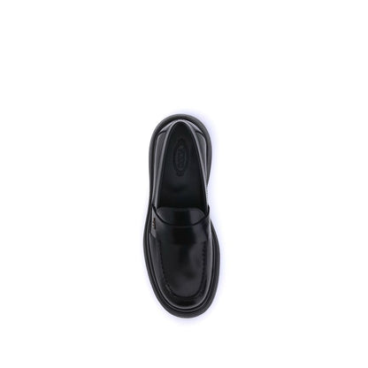 Top view of Tod's Black Rubber Platform Loafers with patent leather and rounded toe, featuring a side logo plaque for a modern look