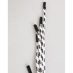 Black and white patterned shoelaces on a light background, close-up view