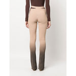 Back view of ANDREĀDAMO Andrea Adamo Trousers Brown with ribbed flared design, ombré effect, high-waisted cut-out style.