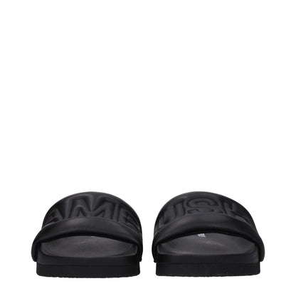 Ambush Black Leather Slippers with front logo, open toe design, and rubber sole.
