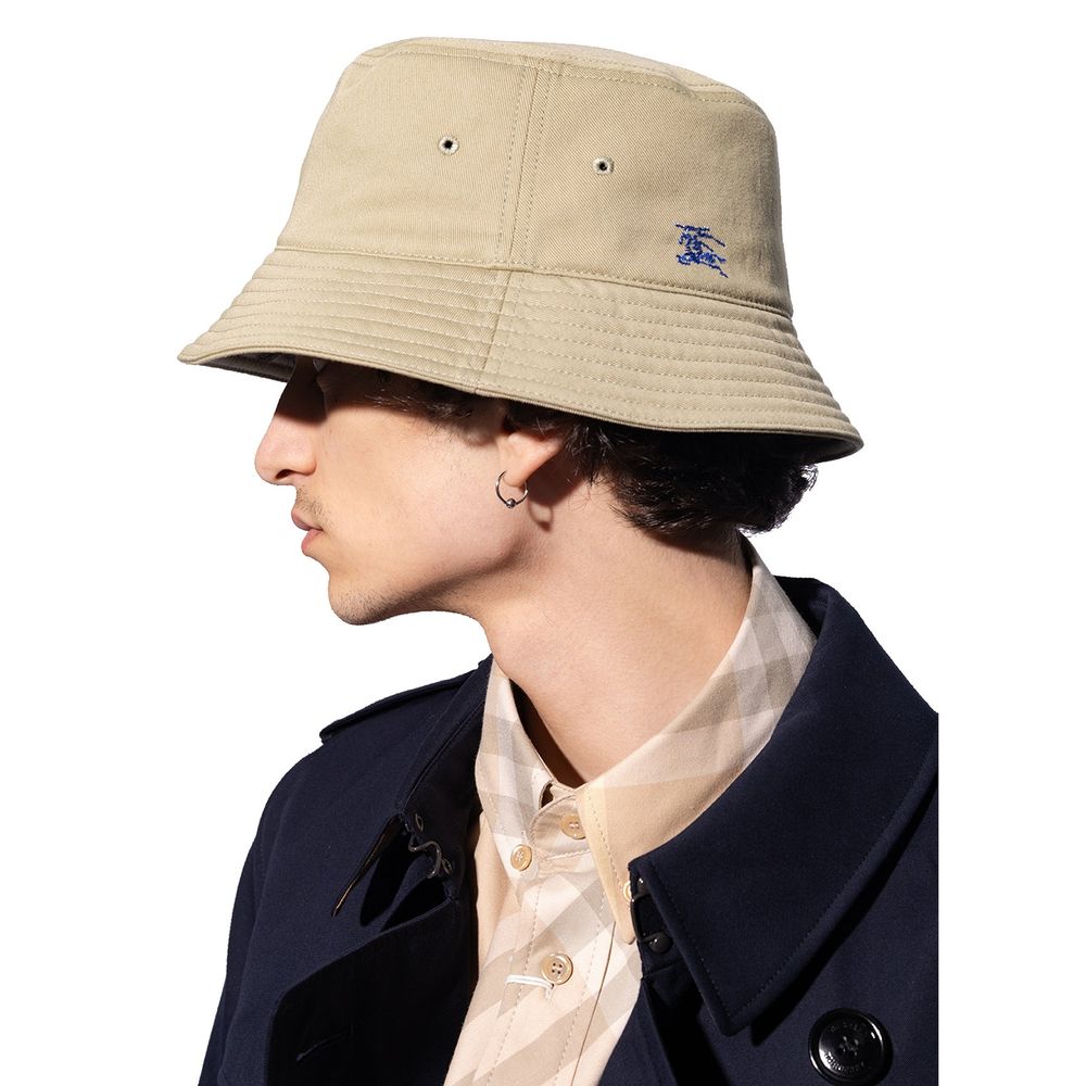 Man wearing Burberry Cotton Bucket Cap with Pegaso embroidery, flat crown, and low wide brim, featuring the Equestrian Knight motif.