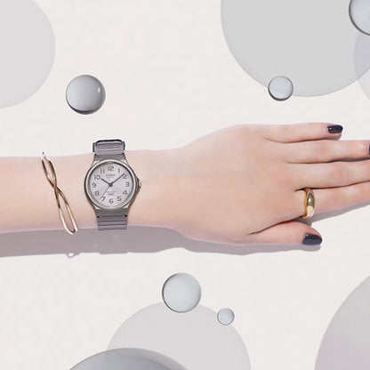 CASIO COLLECTION Mod. POP TRANSLUCID GREY wristwatch on a wrist with gold ring and bracelet, showcasing time-only function, unisex design.