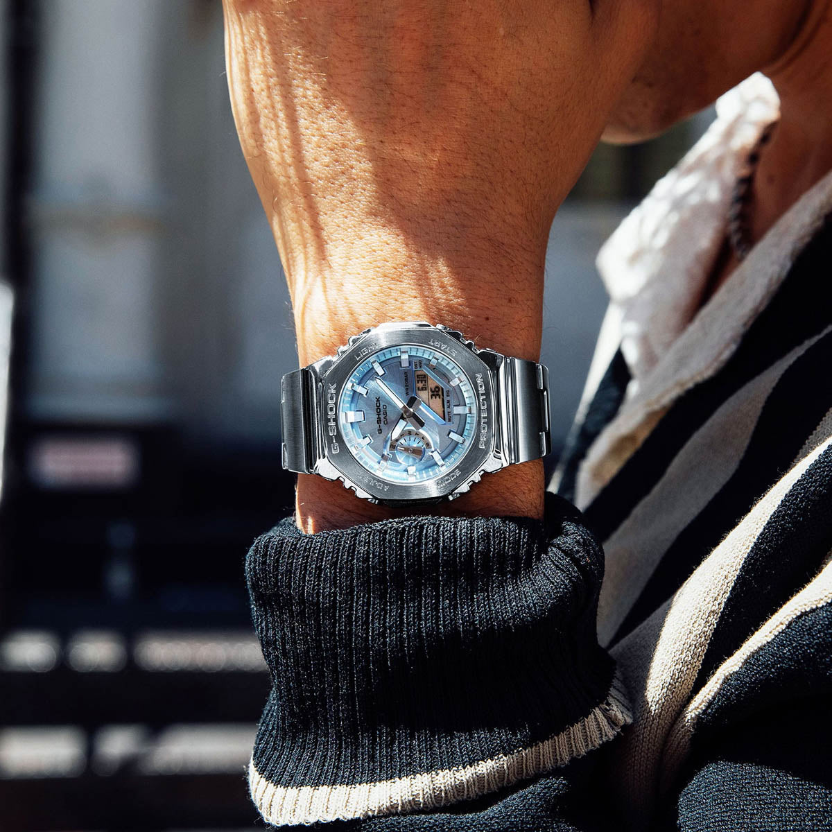 Person wearing CASIO MOD. GM-2110D-2AER watch on wrist outdoors