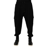 Dolce & Gabbana Black Cotton Blend Cargo Joggers Drawstring Pants with elastic waistband and side flap cargo pockets, front view.