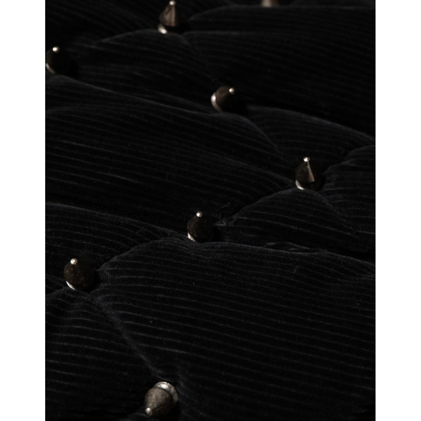 Close-up of Dolce & Gabbana Black Cotton Quilted Studded Sleeve Hoodie Jacket's quilted corduroy detail with metallic studs.