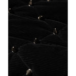 Close-up of Dolce & Gabbana Black Cotton Quilted Studded Sleeve Hoodie Jacket's quilted corduroy detail with metallic studs.