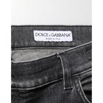 Close-up view of Dolce & Gabbana Black Gray Wash Slim Fit Straight Leg Denim Jeans showcasing brand label and fabric texture.