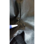 Close-up of defect repair on Dolce & Gabbana Black Leather Elastic Waist Trouser Pants.