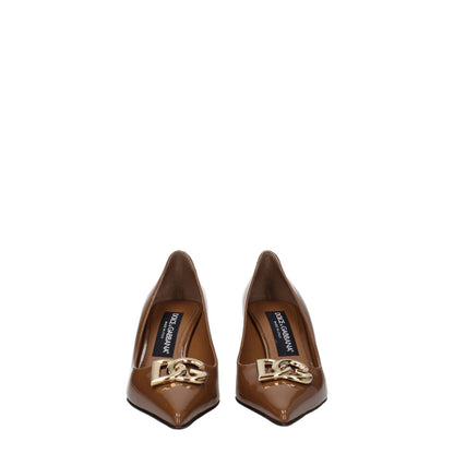 Dolce & Gabbana Brown Leather High Heel Pumps with front logo, pointy toe, mid heels, and caramel accents.