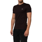 Model wearing Dolce & Gabbana Brown Logo Plaque Cotton Crew Neck T-shirt with crew neckline and logo plaque.