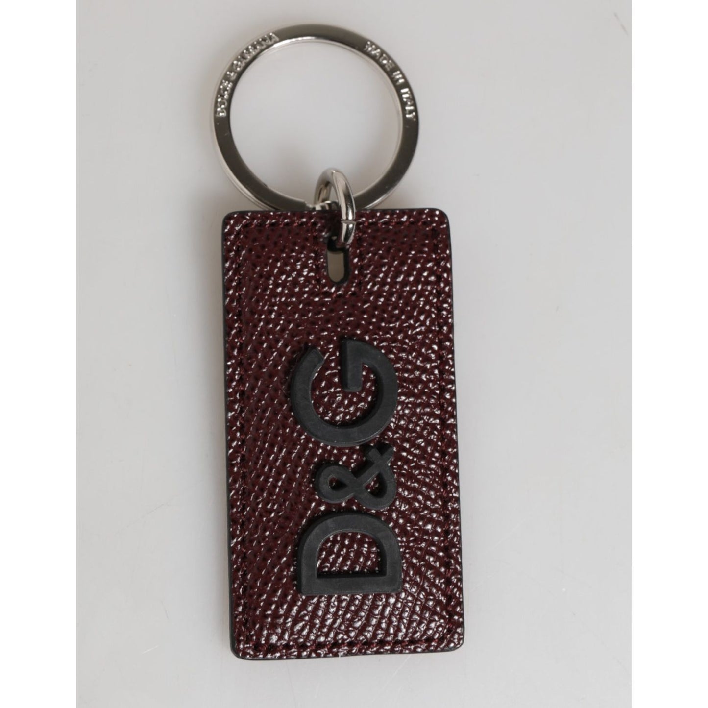 Dolce & Gabbana Dark Brown Leather Logo Metal Ring Men Keychain Keyring with engraved logo on silver ring and textured leather tag.