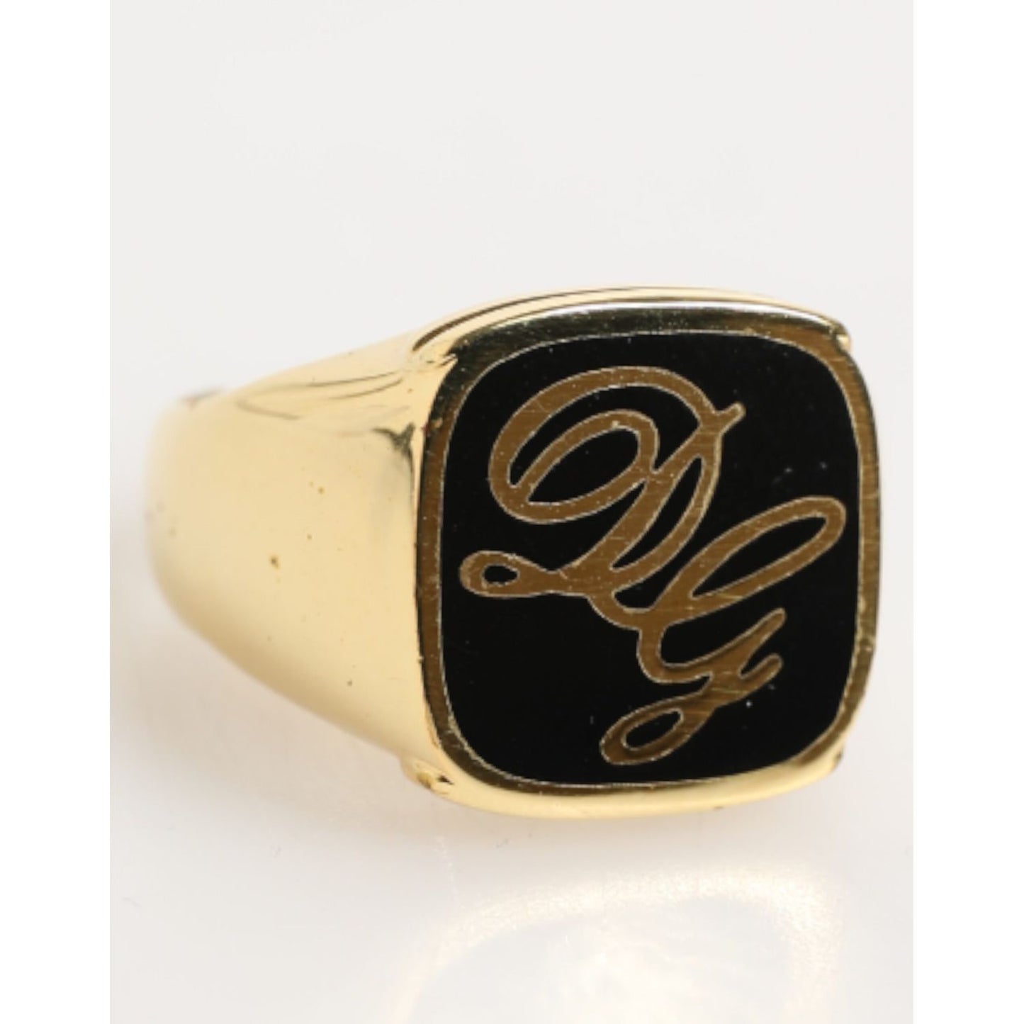 Dolce & Gabbana Gold Tone Enamel Brass Signet DG Logo Adjustable Ring, featuring engraved DG script on black enamel, luxury jewelry piece