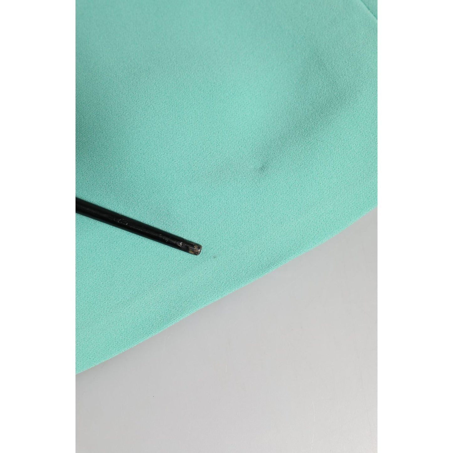 Close-up of Dolce & Gabbana green viscose sheath midi dress fabric with small blemish
