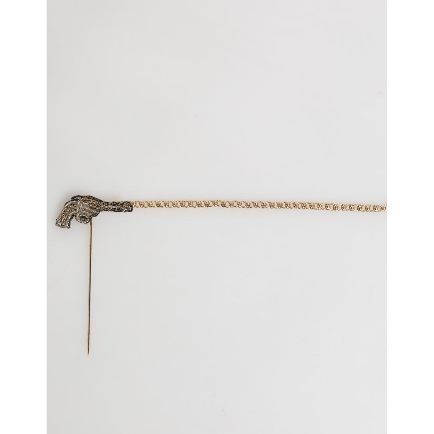 Dolce & Gabbana Lapel Pin Brass Copper Revolver Men Accessories Brooch in aged gold-tone finish on white background.