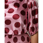 Dolce & Gabbana Pink Red Polka Dot Silk Satin Maxi Gown Dress with puffed sleeves and smocked waist details, close-up view.