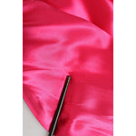 Close-up of Dolce & Gabbana Pink Sheath Silk Bow Open Shoulder Dress fabric in vibrant fuchsia silk with luxurious smooth texture.