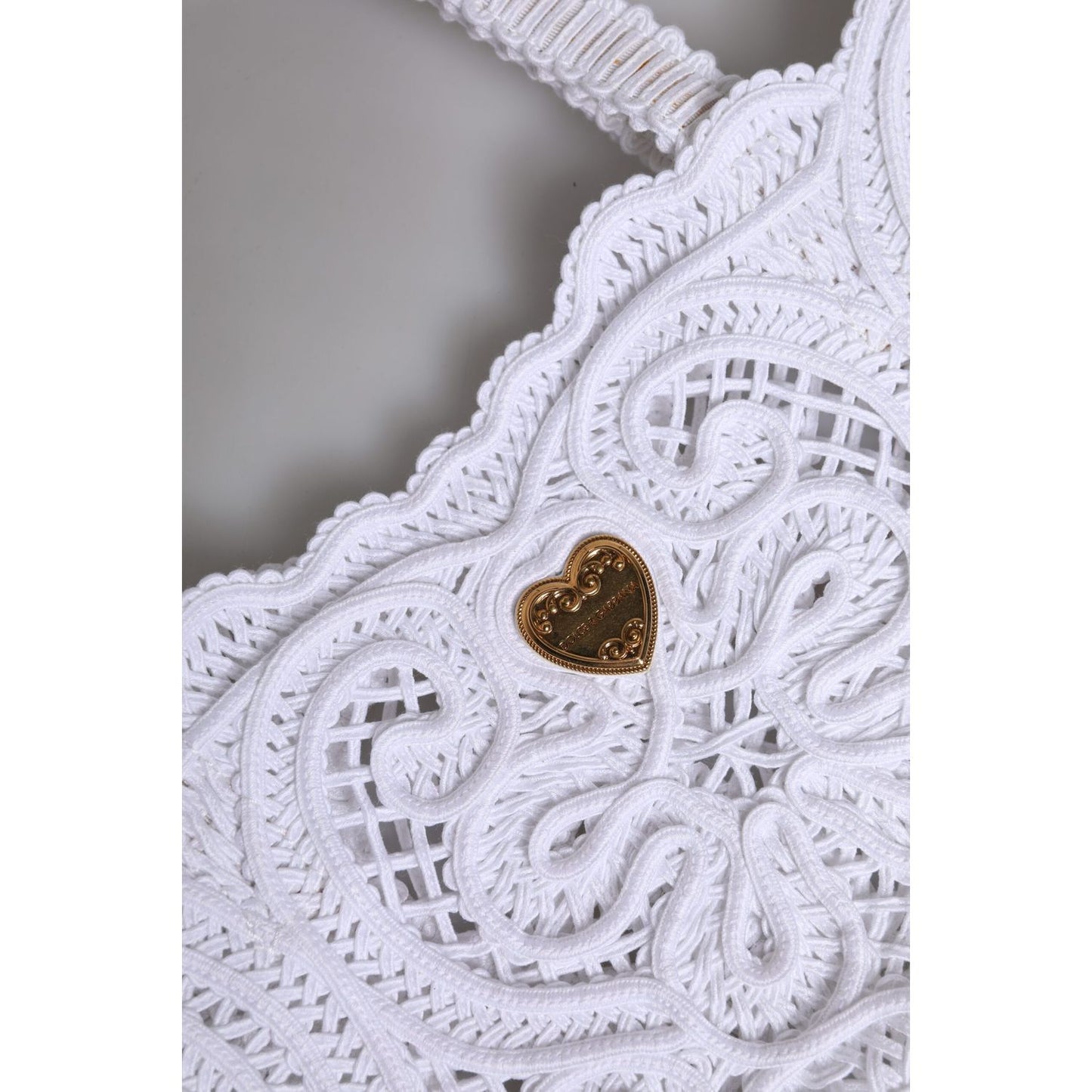 Close-up of Dolce & Gabbana White Cordonetto Lace Beatrice Tote Shopping Bag featuring heart motif and intricate lace design.