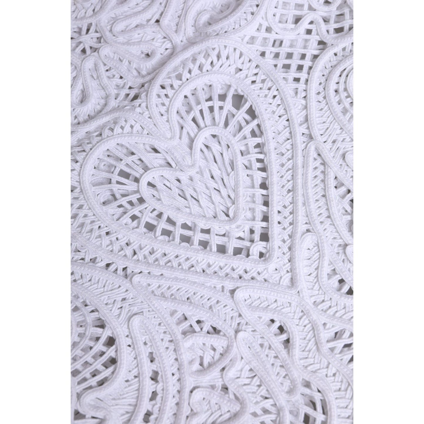 Close-up of Dolce & Gabbana White Cordonetto Lace Beatrice Tote Shopping Bag featuring intricate heart motif in fabric design.