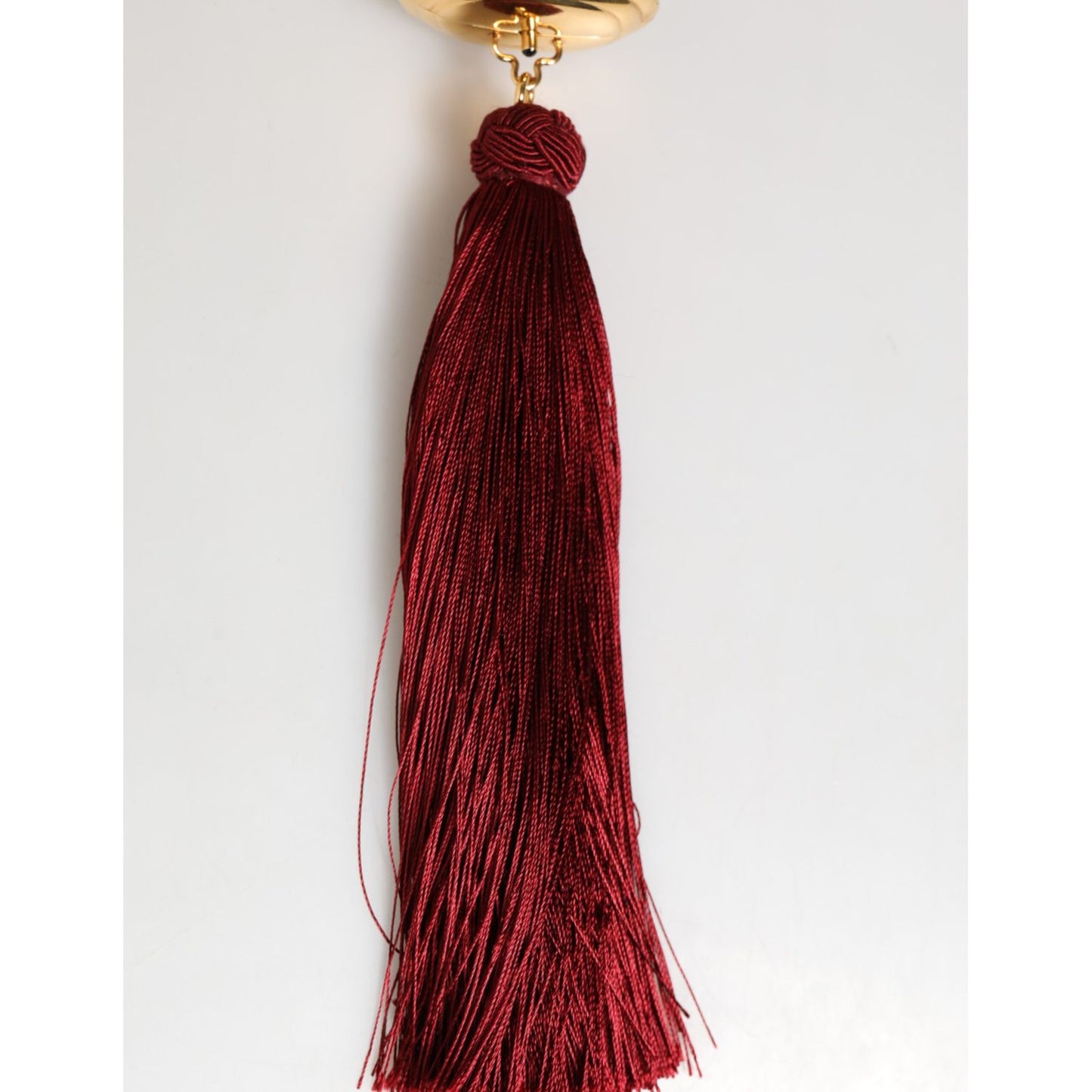 Dolce & Gabbana White Pearl Resin Gold Metal Red Tassel Pendant Bag with luxury design and elegant red tassel.