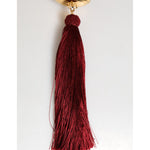 Dolce & Gabbana White Pearl Resin Gold Metal Red Tassel Pendant Bag with luxury design and elegant red tassel.