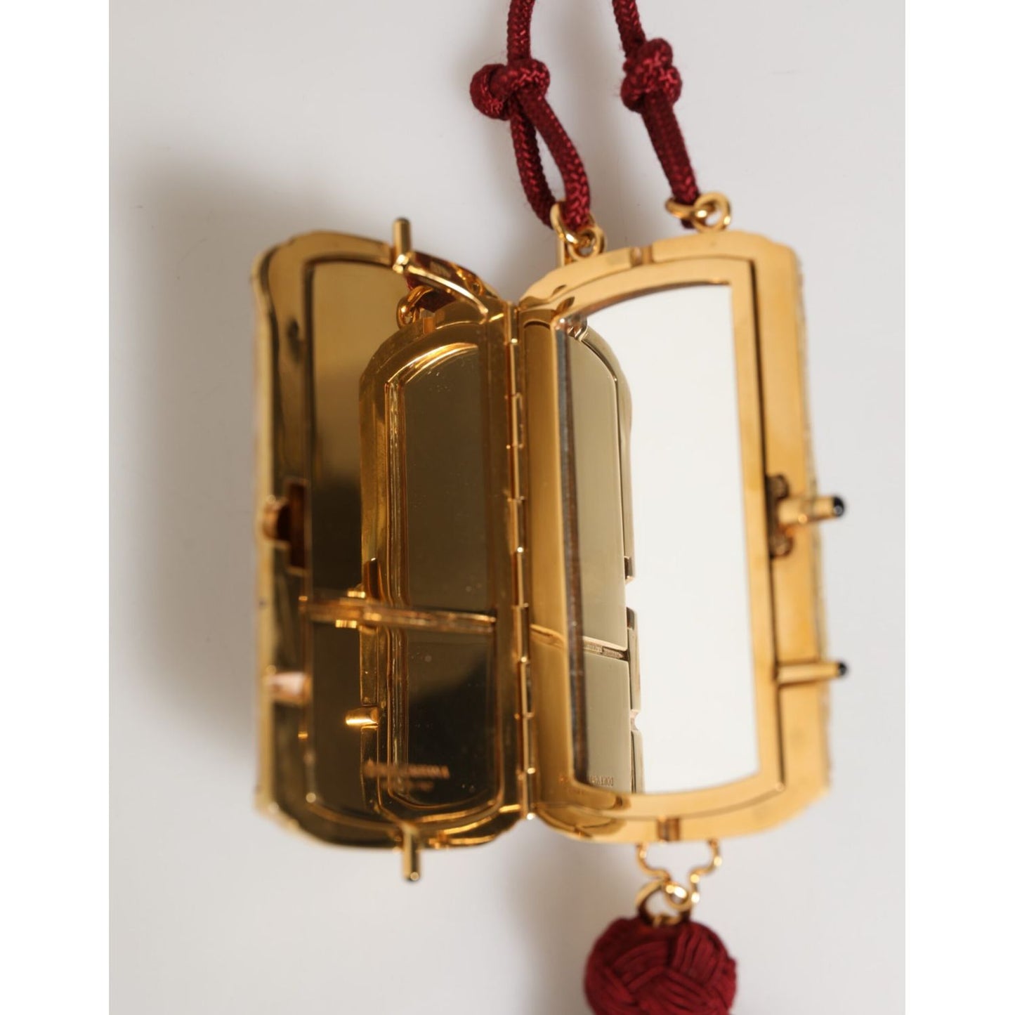 Dolce & Gabbana White Pearl Resin Gold Metal Red Tassel Pendant Bag with mini mirror and deep red tassel charm.