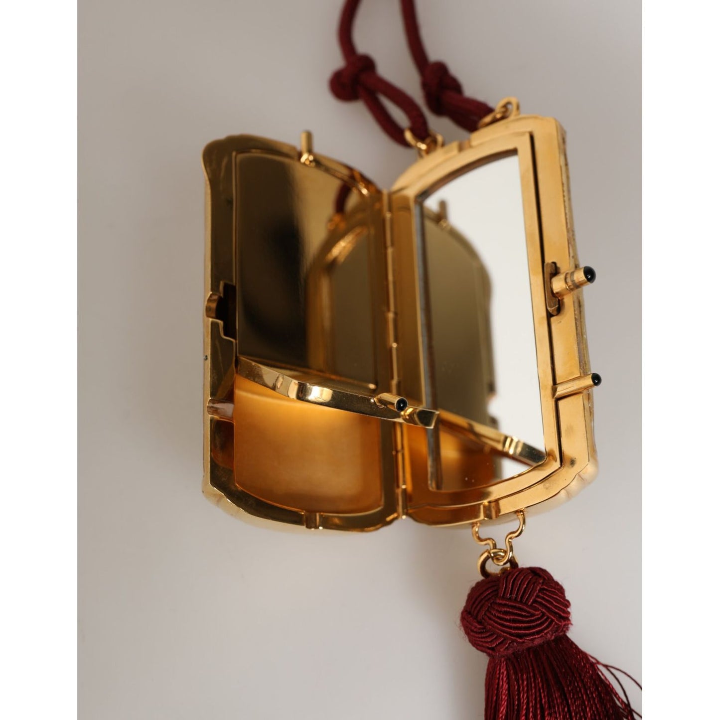Dolce & Gabbana White Pearl Resin Gold Metal Red Tassel Pendant Bag with mini mirror on neck strap.