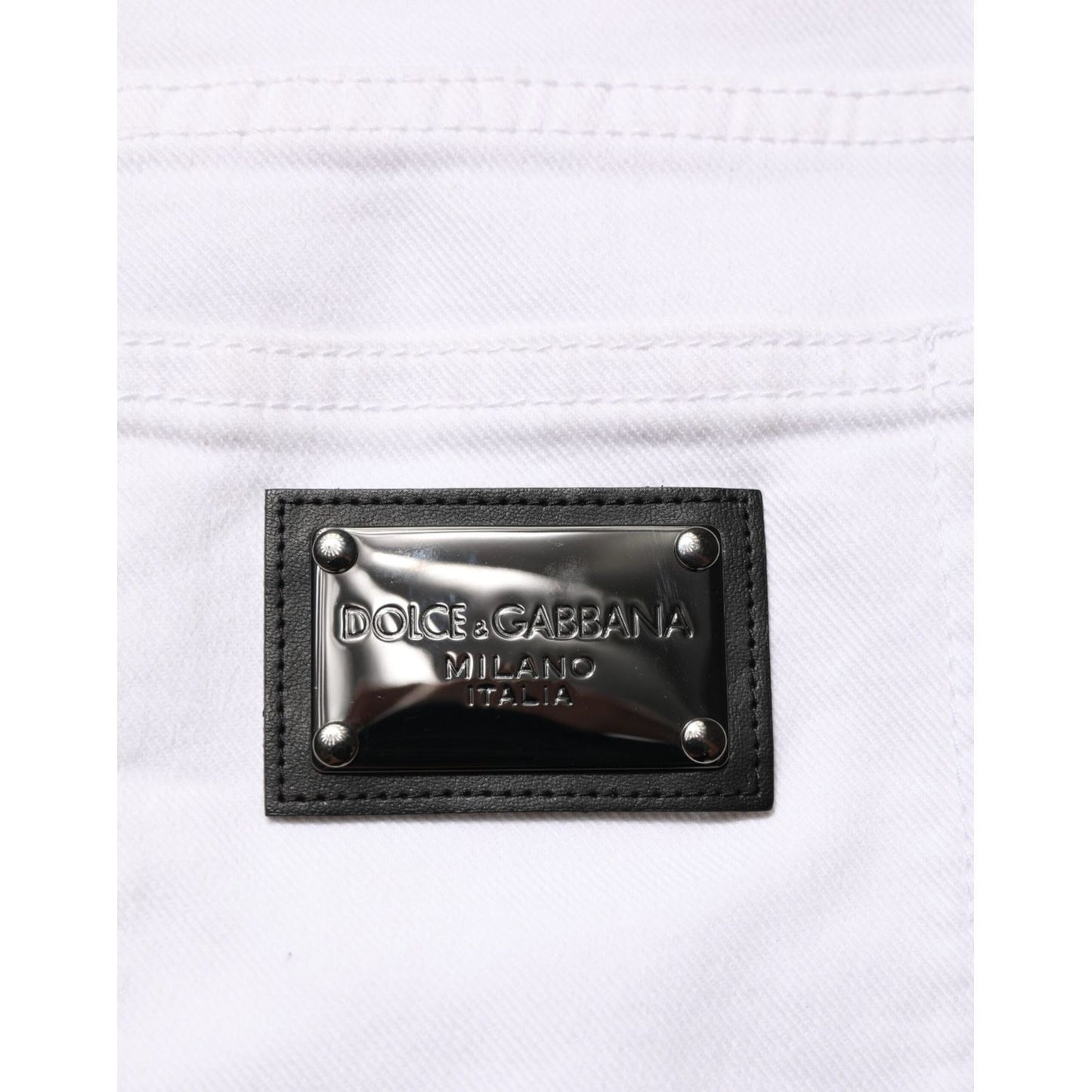 Close-up of Dolce & Gabbana White Ripped Cotton Skinny Men Denim Jeans label on back pocket.