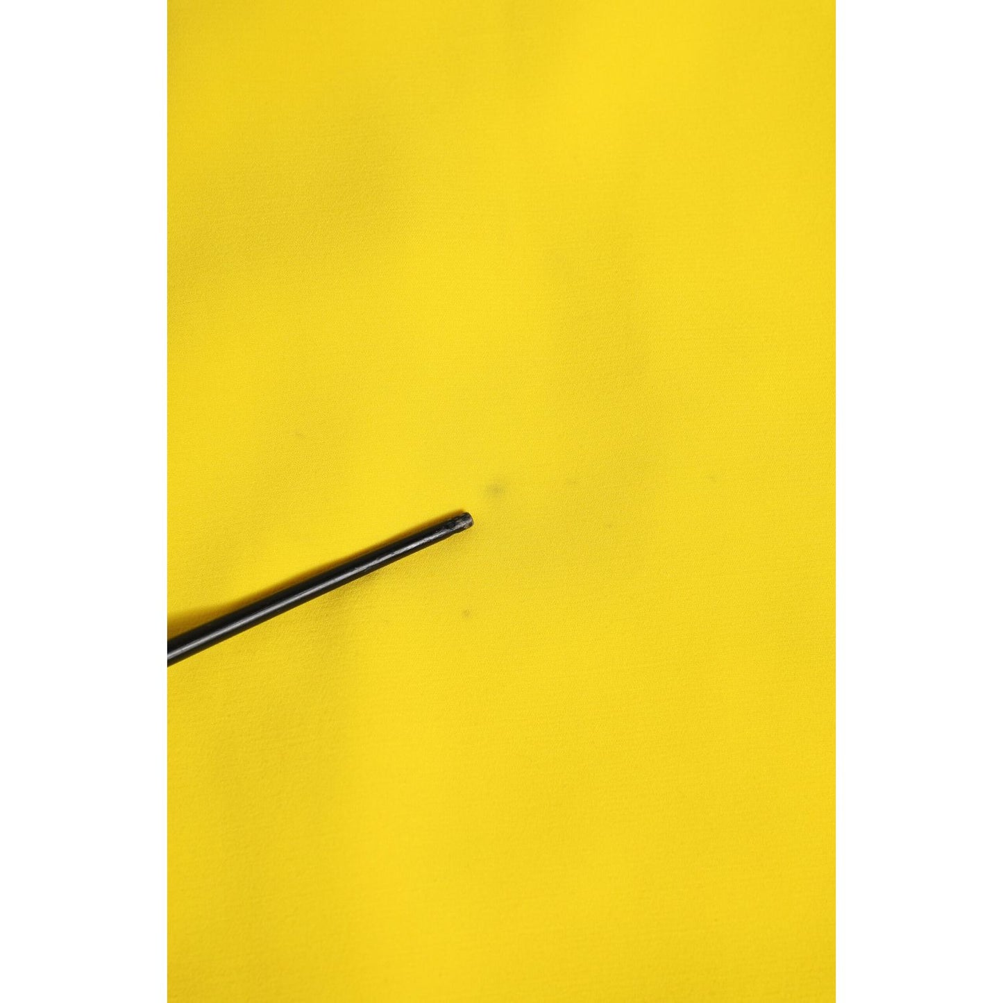 Close-up fabric detail of Dolce & Gabbana Yellow Polyester Sleeveless Sheath Midi Dress highlighting texture and color.