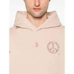 Model wearing Emporio Armani Sweaters Powder in blush pink with hood, drop shoulder, and logo print.
