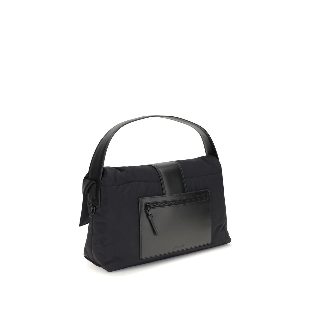 Jacquemus Black Nylon Shoulder Bag with leather handle, magnetic flap, zipper closure, and adjustable grosgrain strap, side view.