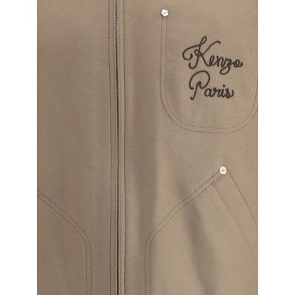 Close-up of Kenzo Brown Leather Jacket showing embroidered logo and pocket details on wool and leather fabric.