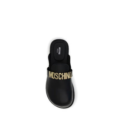 Moschino Black Calf Leather Bos Taurus Mules with golden logo plaque and rounded toe design for AW25 season.