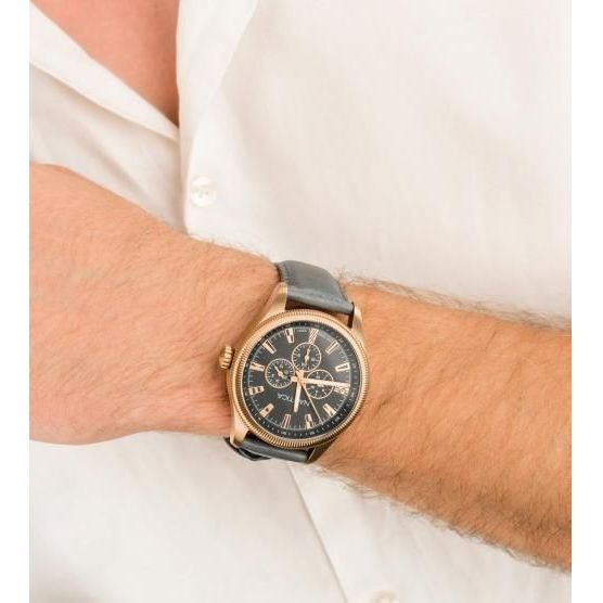 Gent wearing NAUTICA Mod. NAPSTB003 watch with quartz analog movement, 10 ATM water resistance, multifunction dial, in official box.